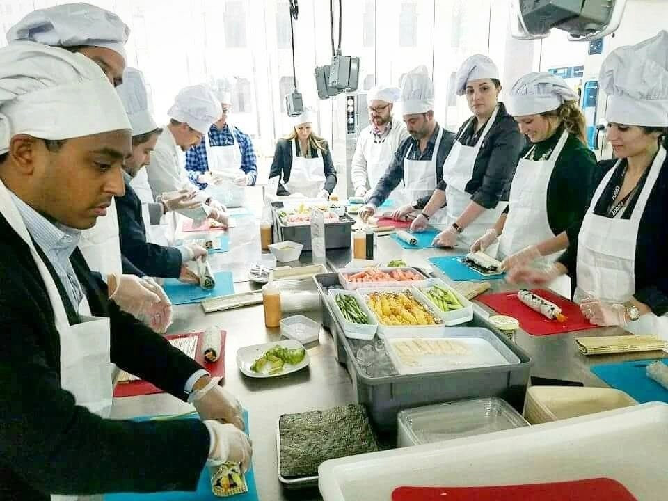 People learning to make sushi together at a Social Sushi class